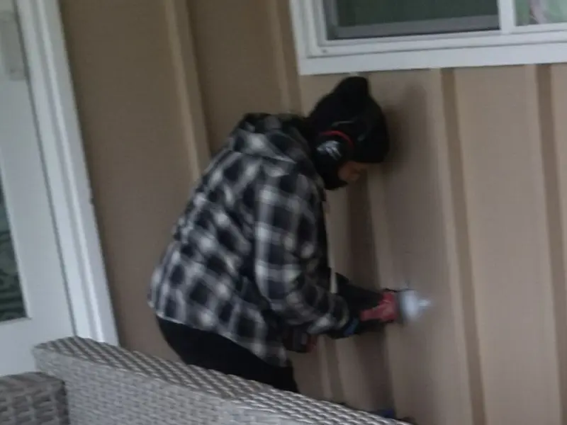 Professional electrician installing an exterior outlet in McLoud